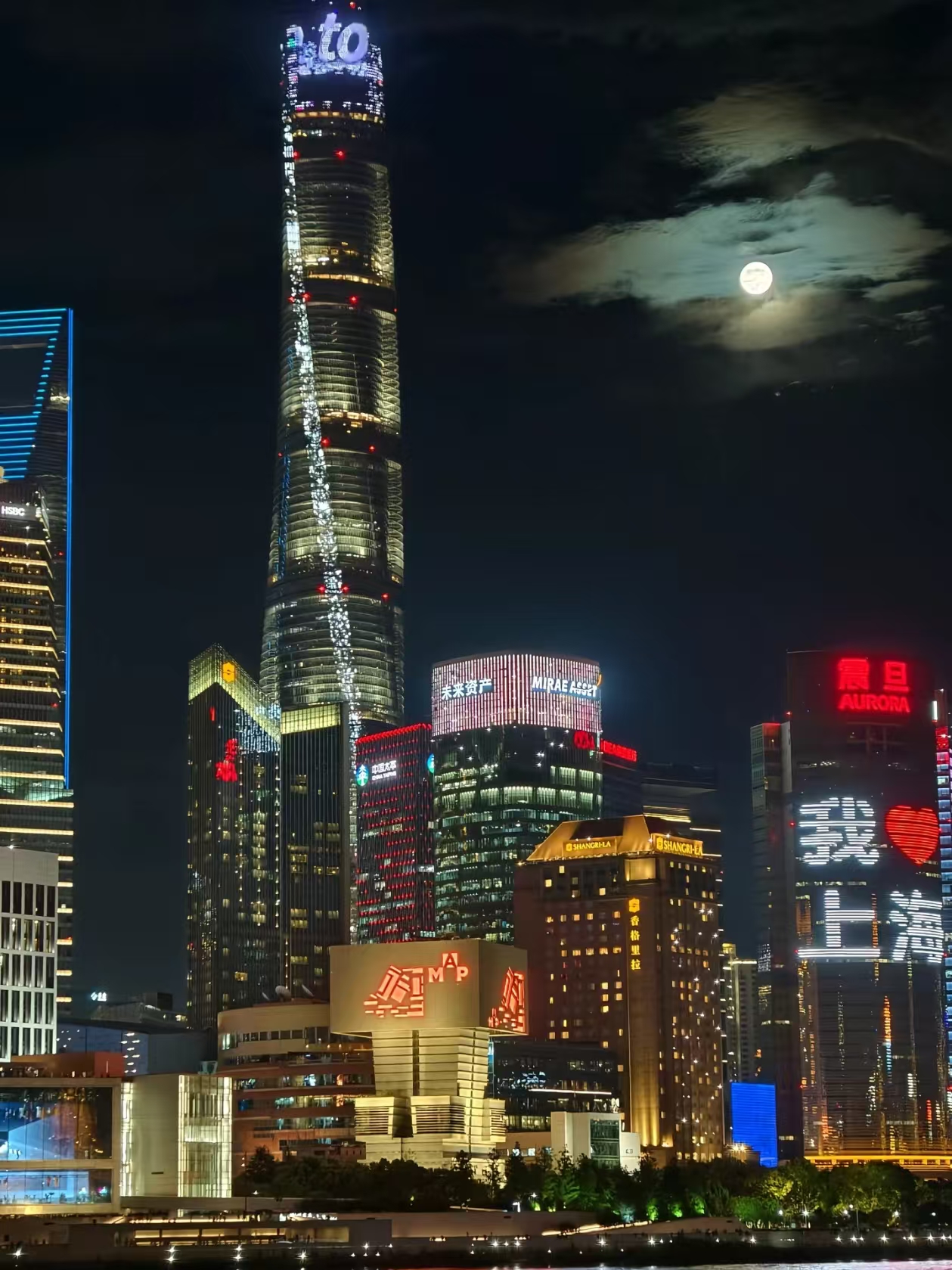 Shanghai Tower at night with full moon